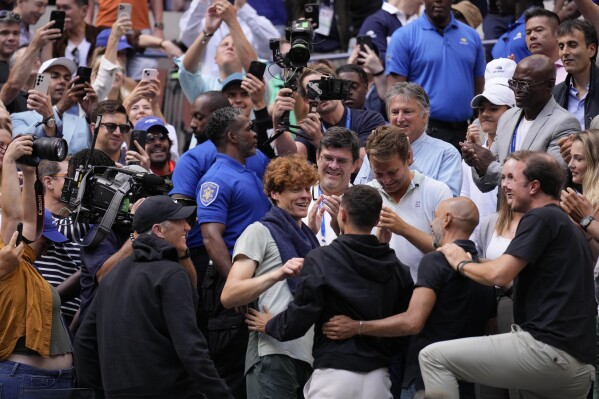 Jannik Sinner gets a hug from his friend Seal after winning the US Open title